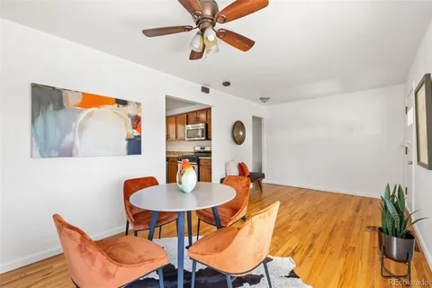 a view of a dining room with a table and chairs