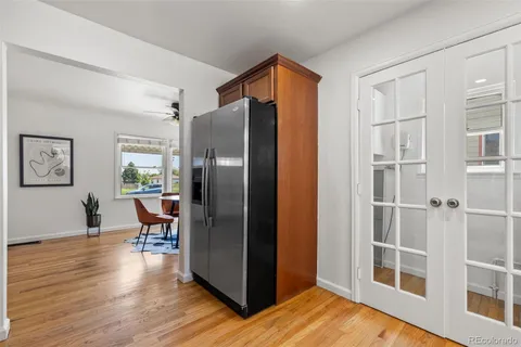 a kitchen with stainless steel appliances wooden floor and dining table