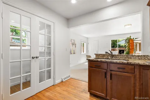 a bathroom with a granite countertop sink a mirror and a shower