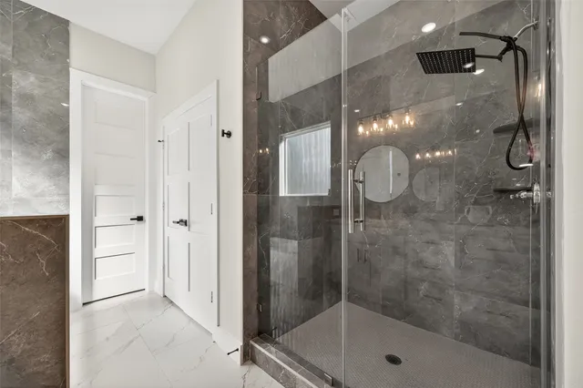 a bathroom with a glass shower door