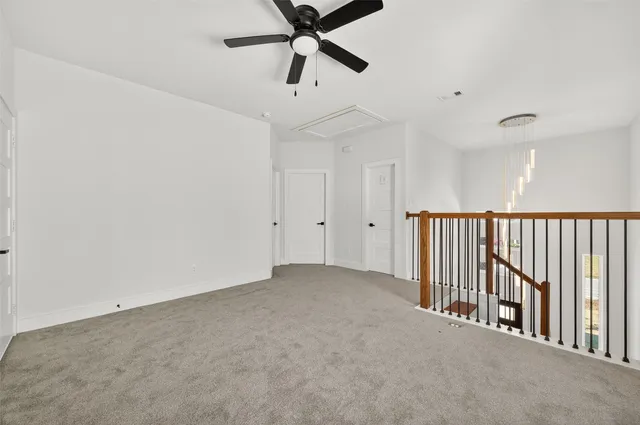 a view of a room with a ceiling fan