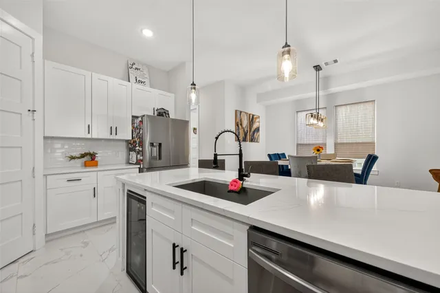 a kitchen with kitchen island a sink appliances and cabinets
