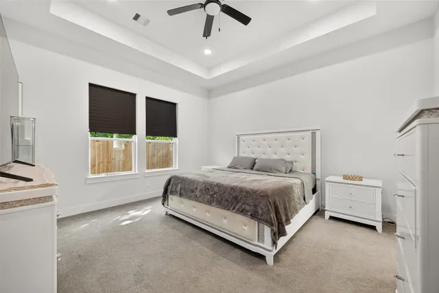 a spacious bedroom with a bed and a large window