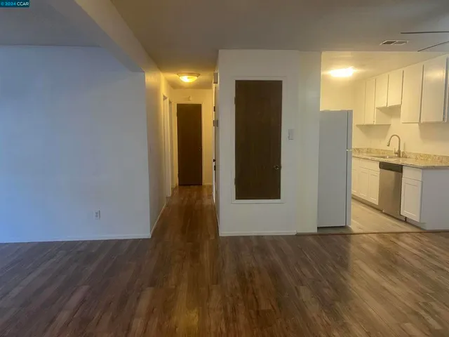a view of a kitchen with wooden floor and a sink