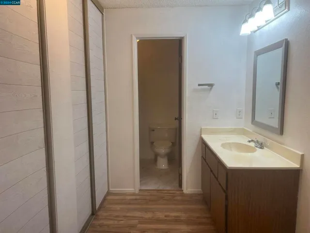 a bathroom with a sink and mirror with toilet