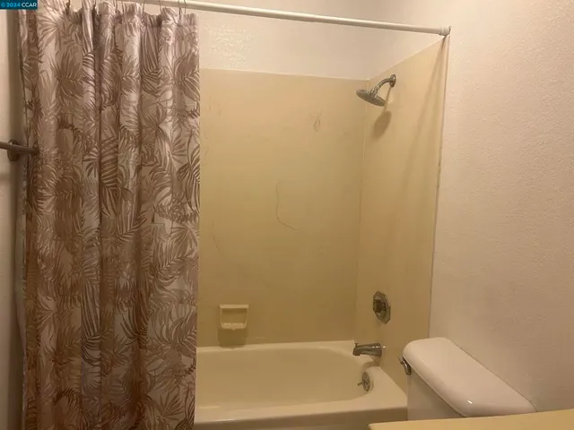 a bathroom with a shower and a sink