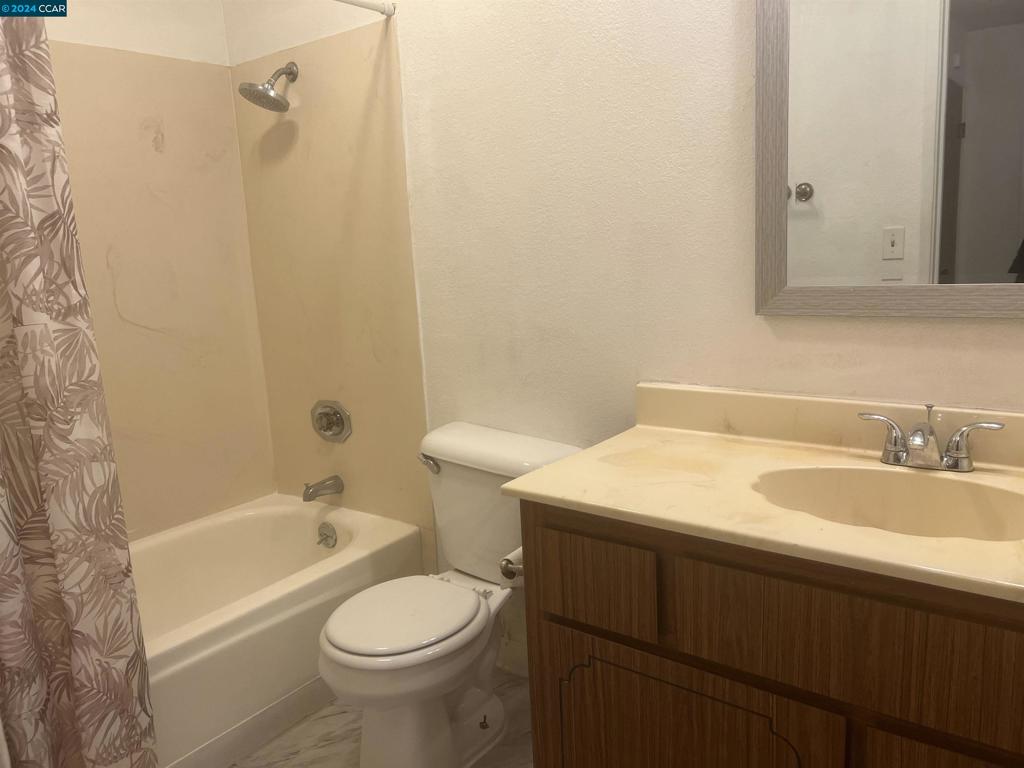 5075 Valley Crest Drive Concord, CA 94521 - Photo 19 of 20 a bathroom with a sink a toilet and shower