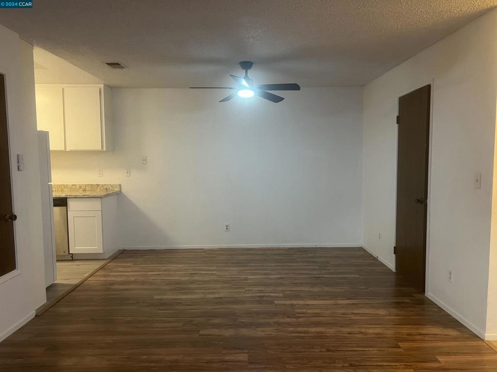 5075 Valley Crest Drive Concord, CA 94521 - Photo 4 of 20 a view of an empty room with window and wooden floor