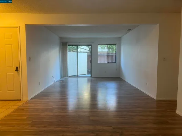 a view of room with window and wooden floor