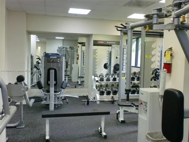 a view of hall way with furniture and chandelier