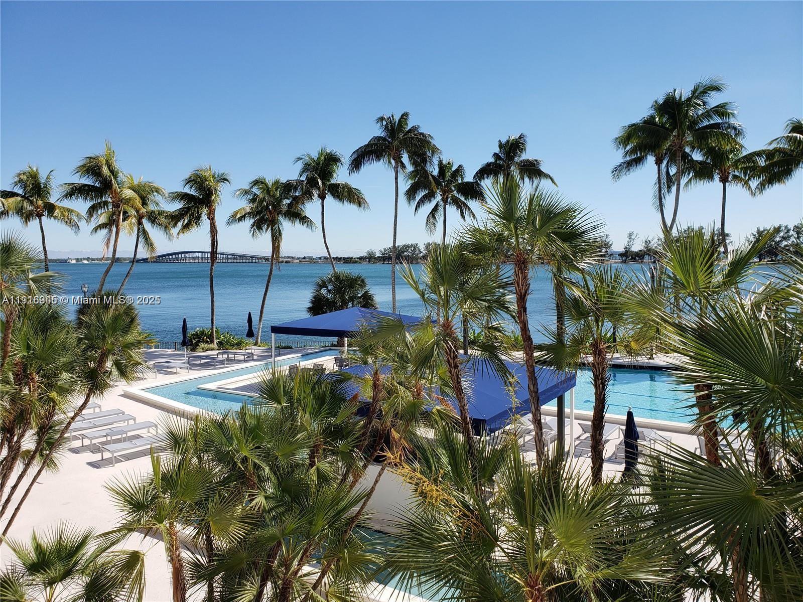 2333 Brickell Avenue, Unit 2215 Miami, FL 33129 - Photo 21 of 27 a swimming pool with outdoor seating and a yard