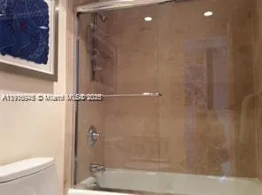 a bathroom with a shower and a toilet