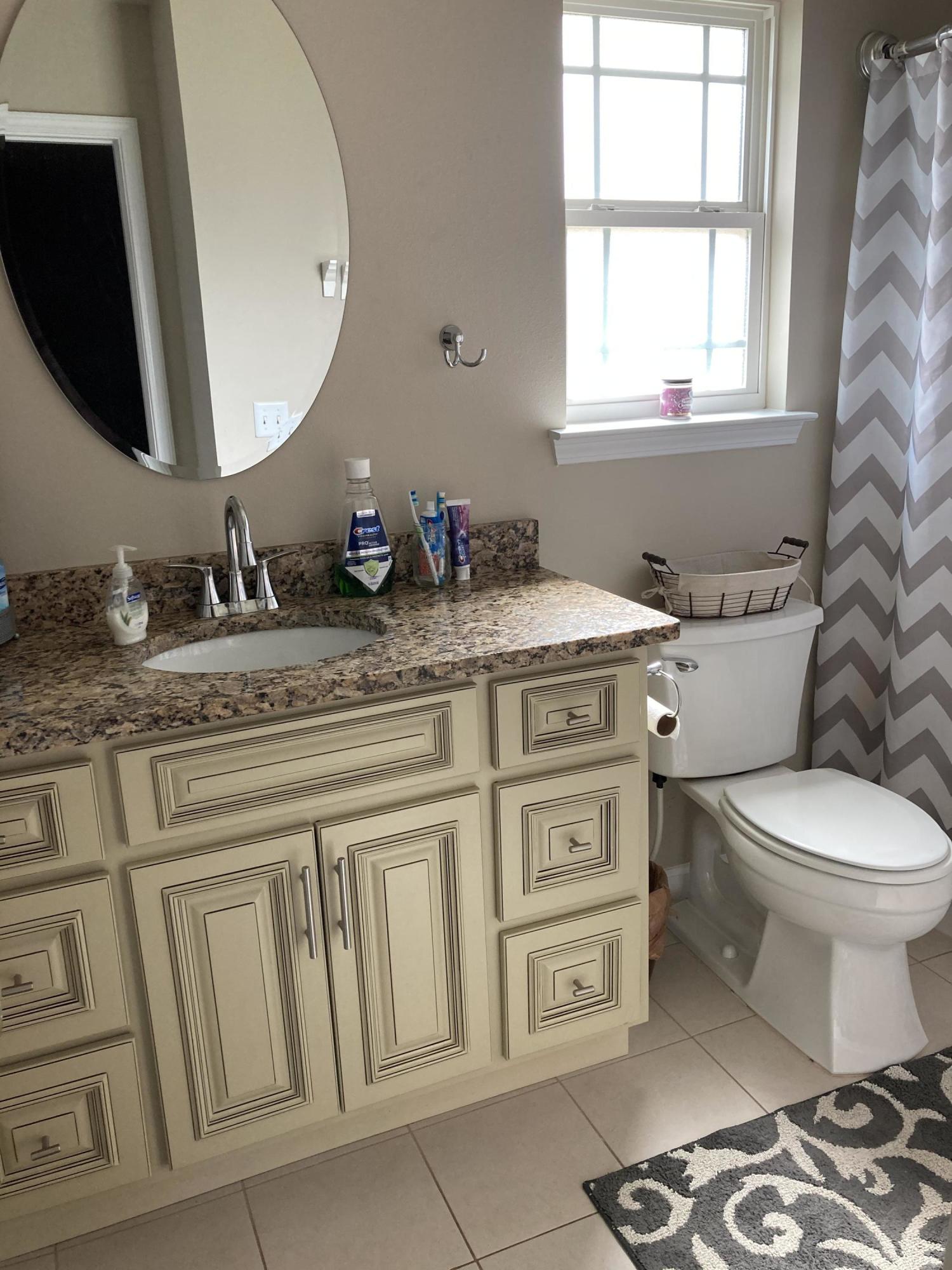 5246 Moore Loop Crestview, FL 32536 - Photo 3 of 7 a bathroom with a granite countertop toilet sink and mirror