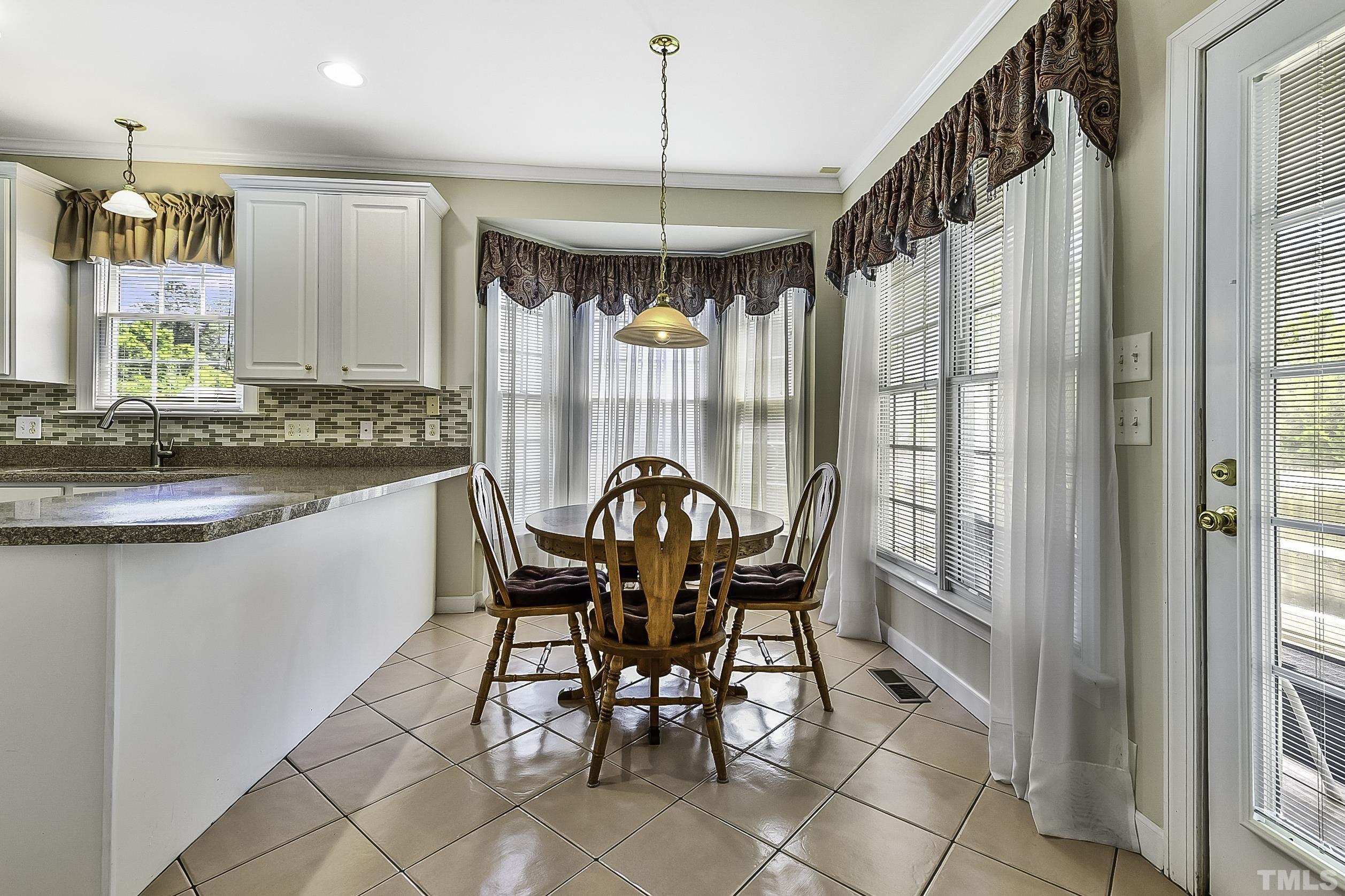 7929 Milltrace Run Raleigh, NC 27615 - Photo 15 of 36 a dining room with furniture and window