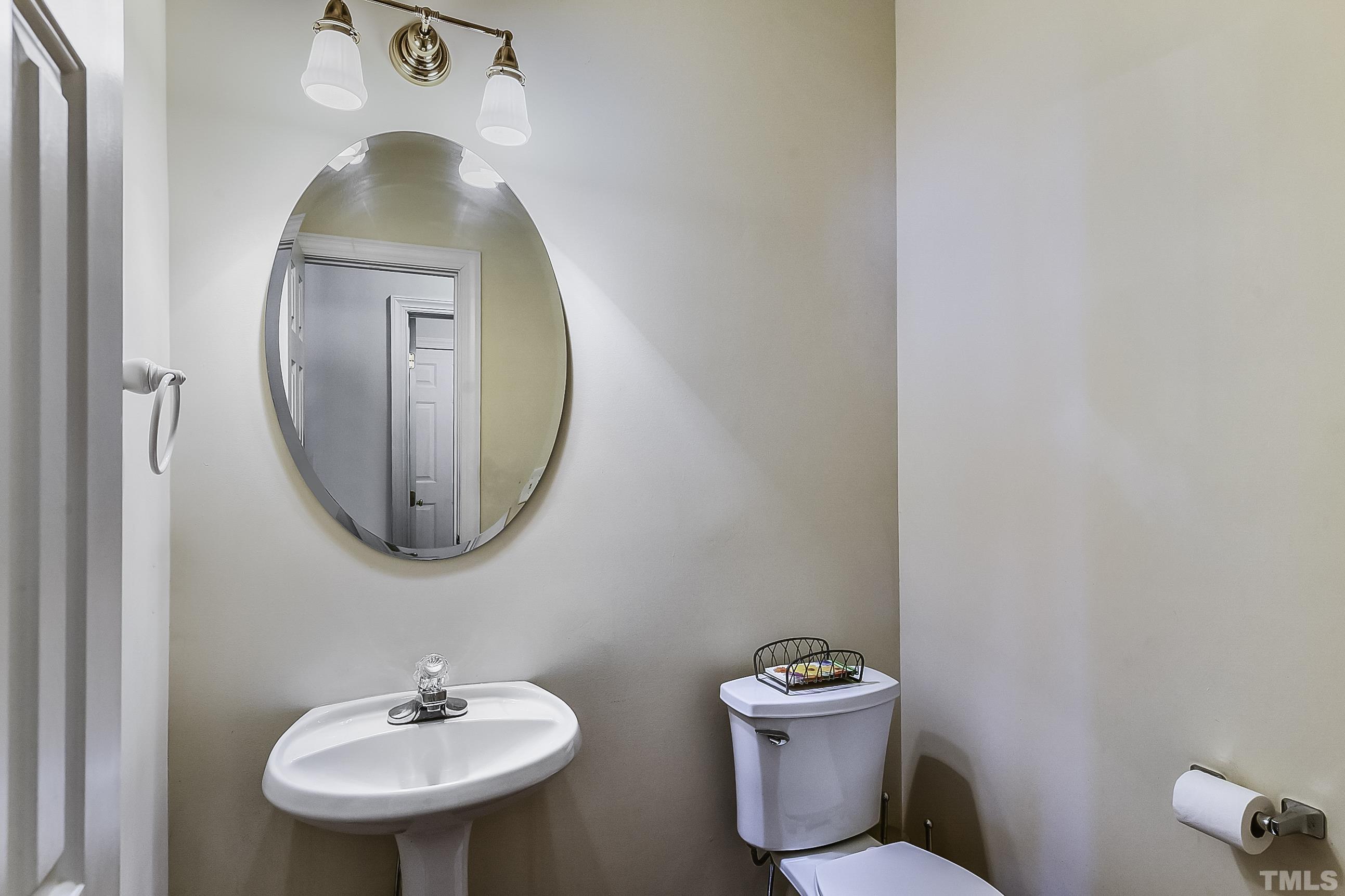 7929 Milltrace Run Raleigh, NC 27615 - Photo 23 of 36 a bathroom with a toilet sink and mirror