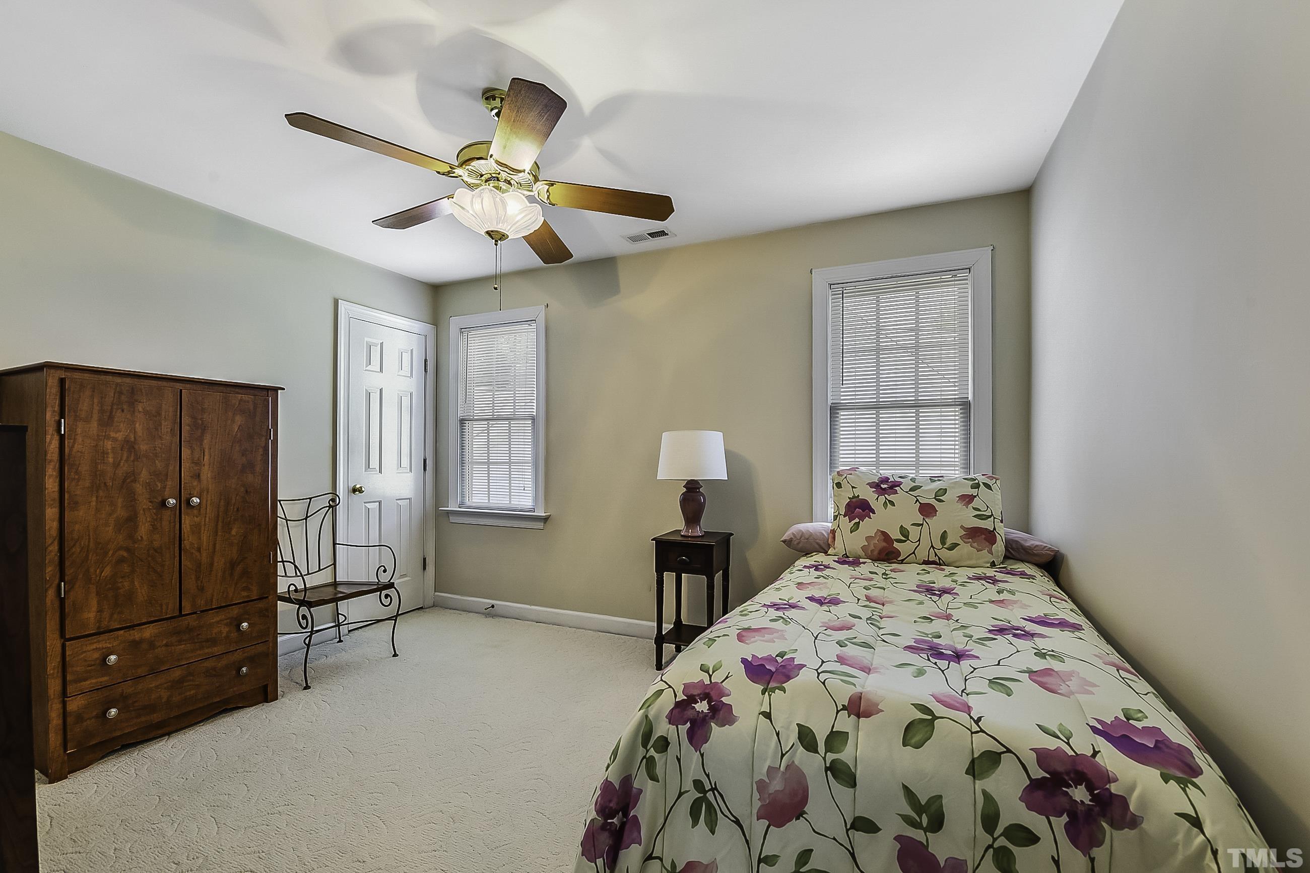 7929 Milltrace Run Raleigh, NC 27615 - Photo 28 of 36 a bedroom with a bed and a window