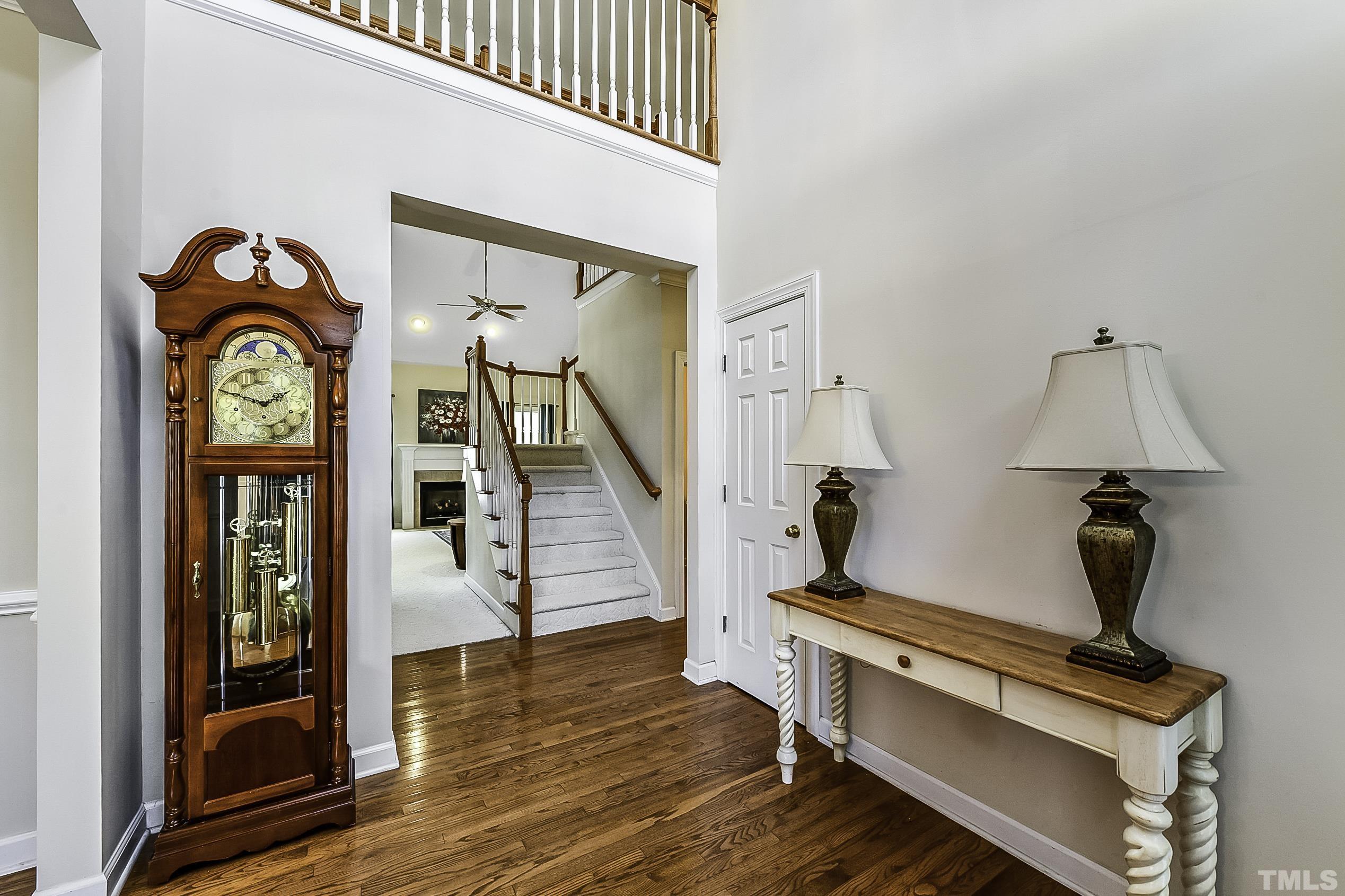 7929 Milltrace Run Raleigh, NC 27615 - Photo 6 of 36 a view of entryway with wooden floor and front door