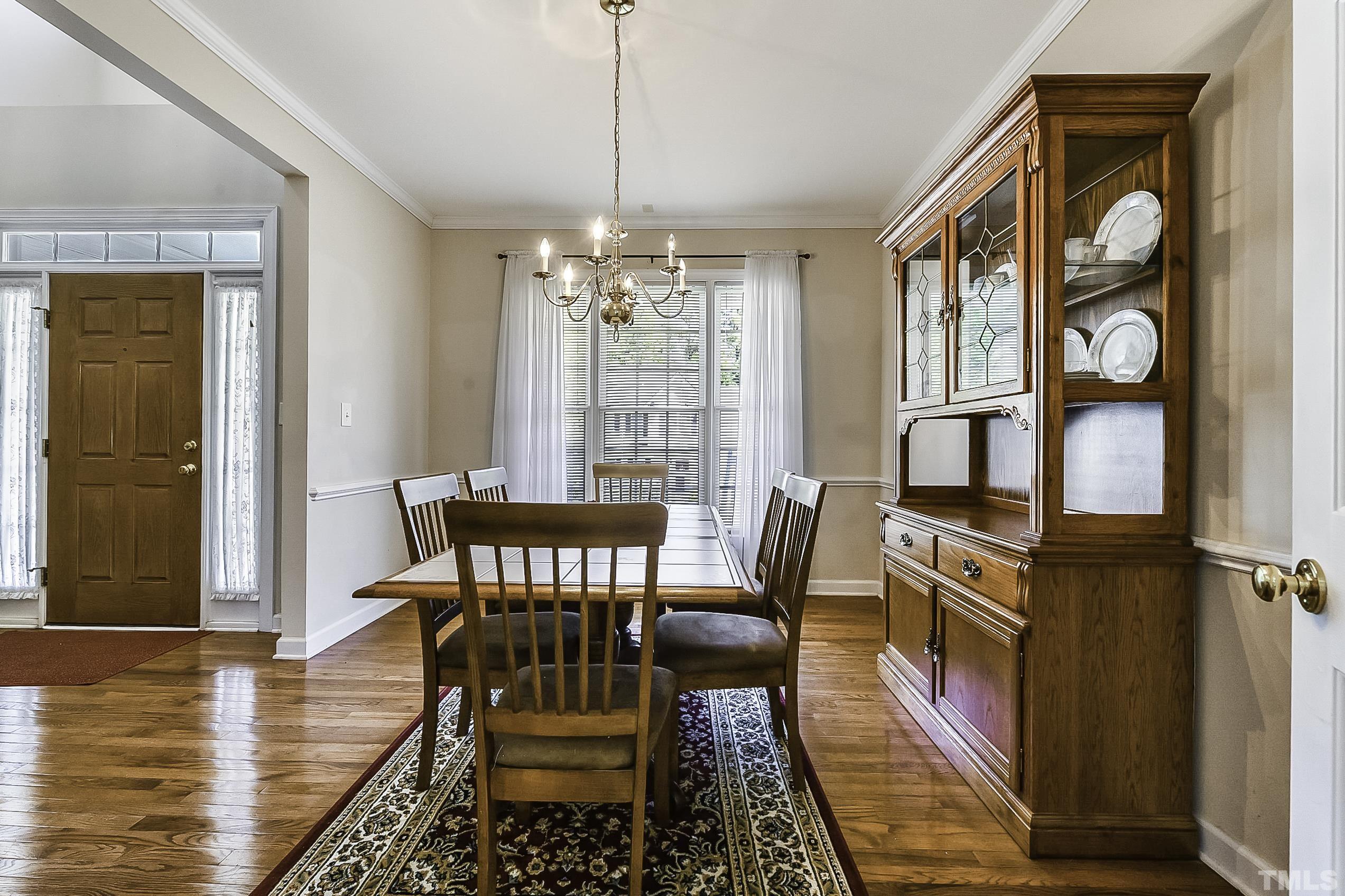 7929 Milltrace Run Raleigh, NC 27615 - Photo 8 of 36 a view of a dining room with furniture window and wooden floor