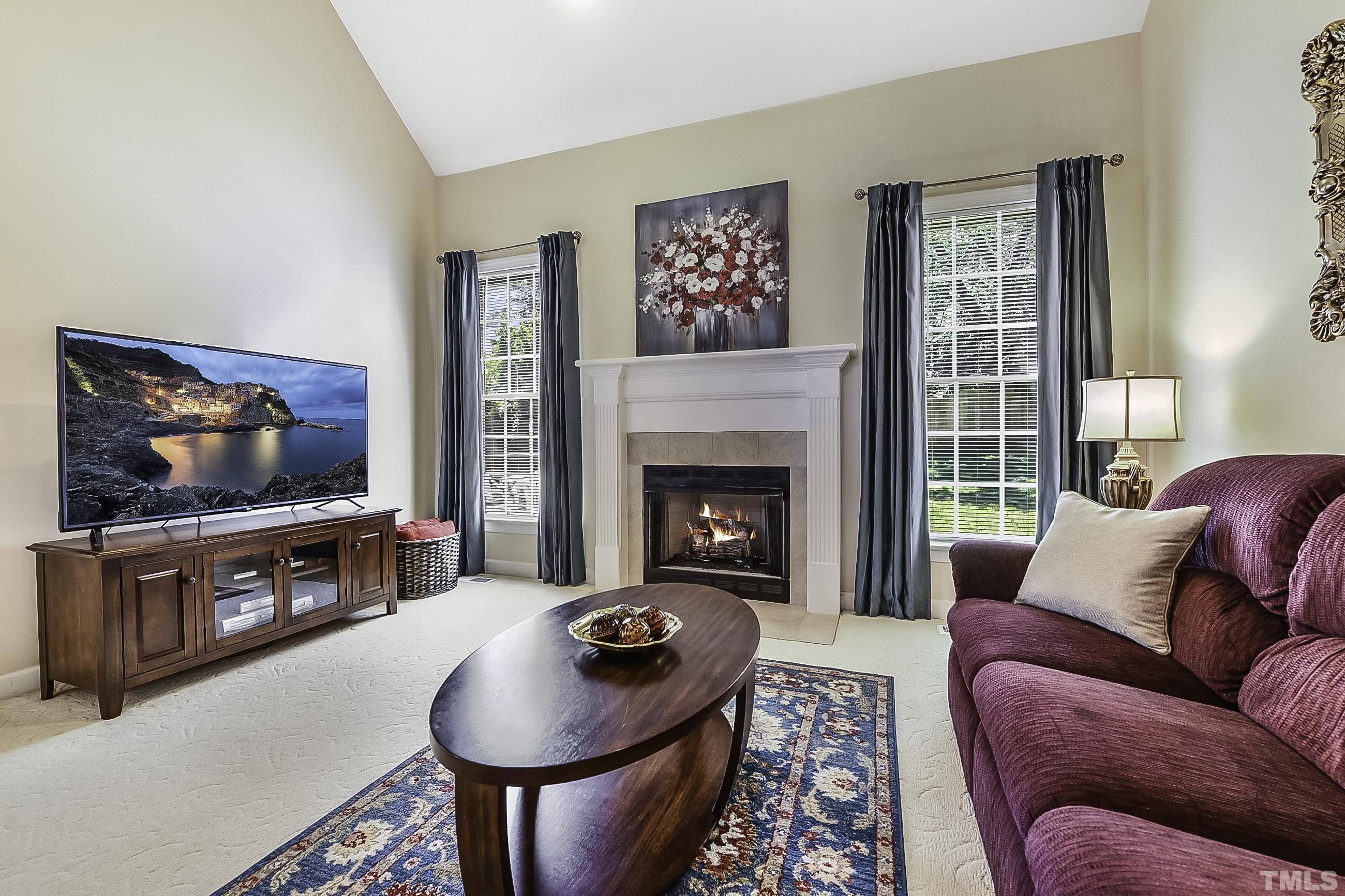 7929 Milltrace Run Raleigh, NC 27615 - Photo 10 of 36 a living room with furniture and a flat screen tv