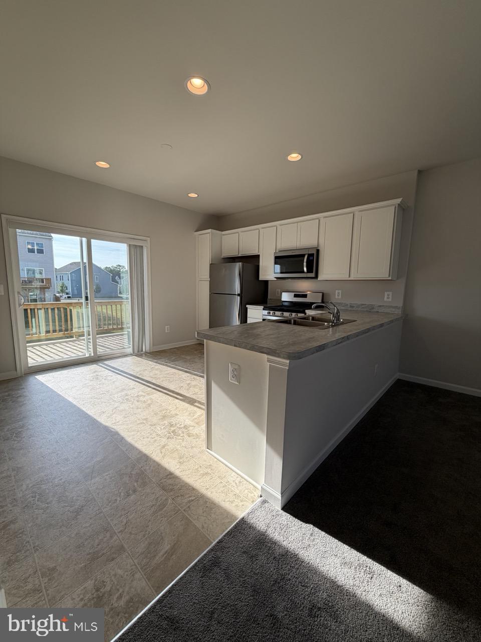 146 Galaxy Place Stephenson, VA 22656 - Photo 12 of 46 a kitchen with stainless steel appliances granite countertop a stove a sink and a refrigerator