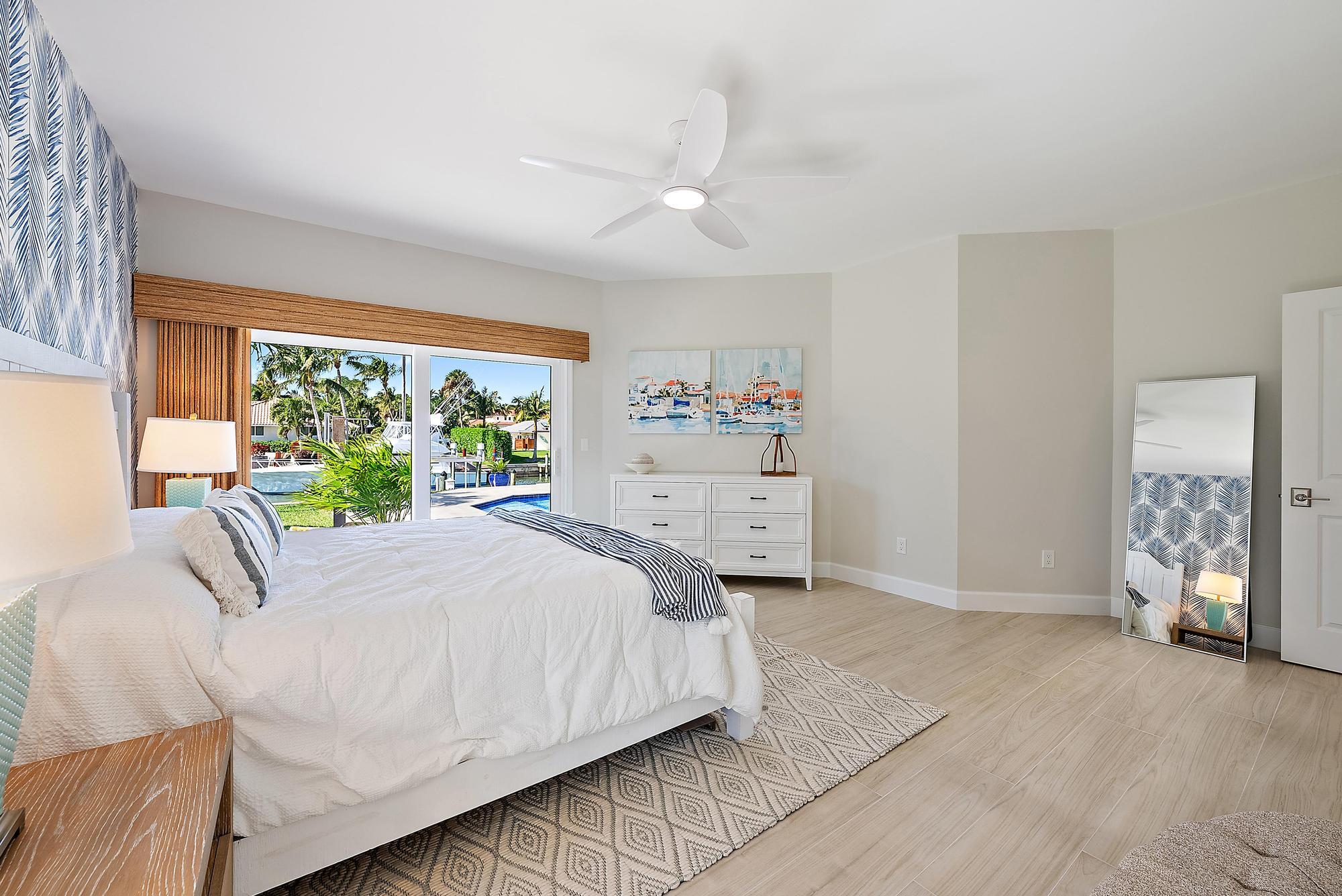 19 Island Road Sewall's Point, FL 34996 - Photo 26 of 50 a bedroom with a bed and a large window