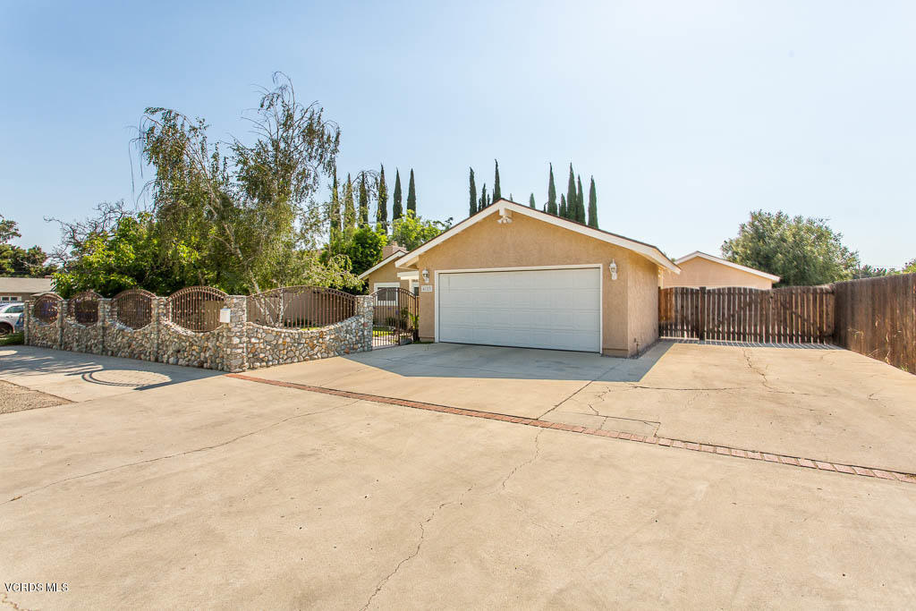 4123 Eve Road Simi Valley, CA 93063 - Photo 3 of 36 a white house with a yard and wooden fence