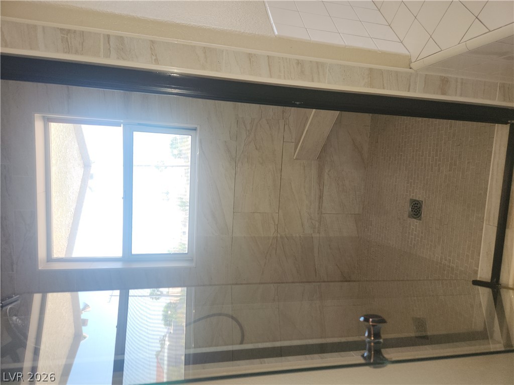 564 Ridgeway Road Henderson, NV 89015 - Photo 11 of 22 A well-lit shower features sleek tile work and a convenient built-in bench.