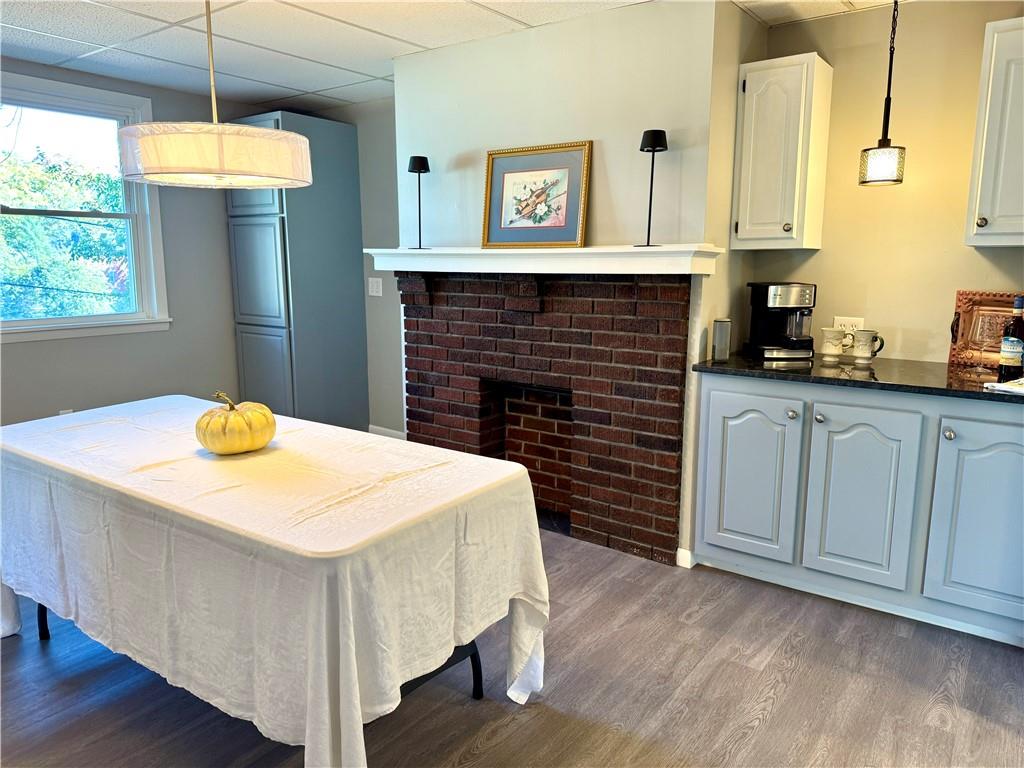 532 North Elm Street Butler, PA 16001 - Photo 14 of 31 a kitchen with a wooden floor and a fireplace