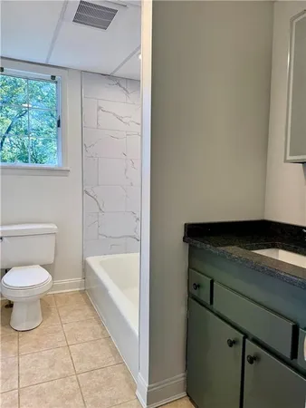 a bathroom with a sink a toilet and bathtub