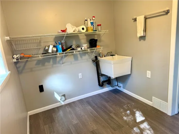 an empty room with wooden floor and window