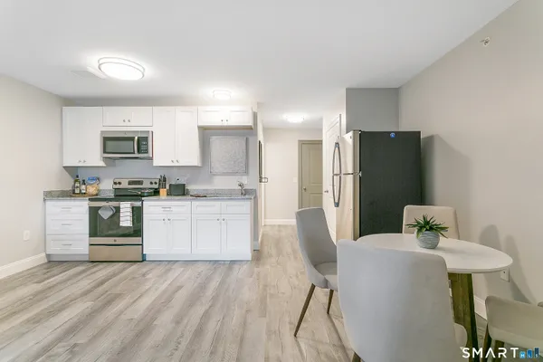 a kitchen with white cabinets and a sink