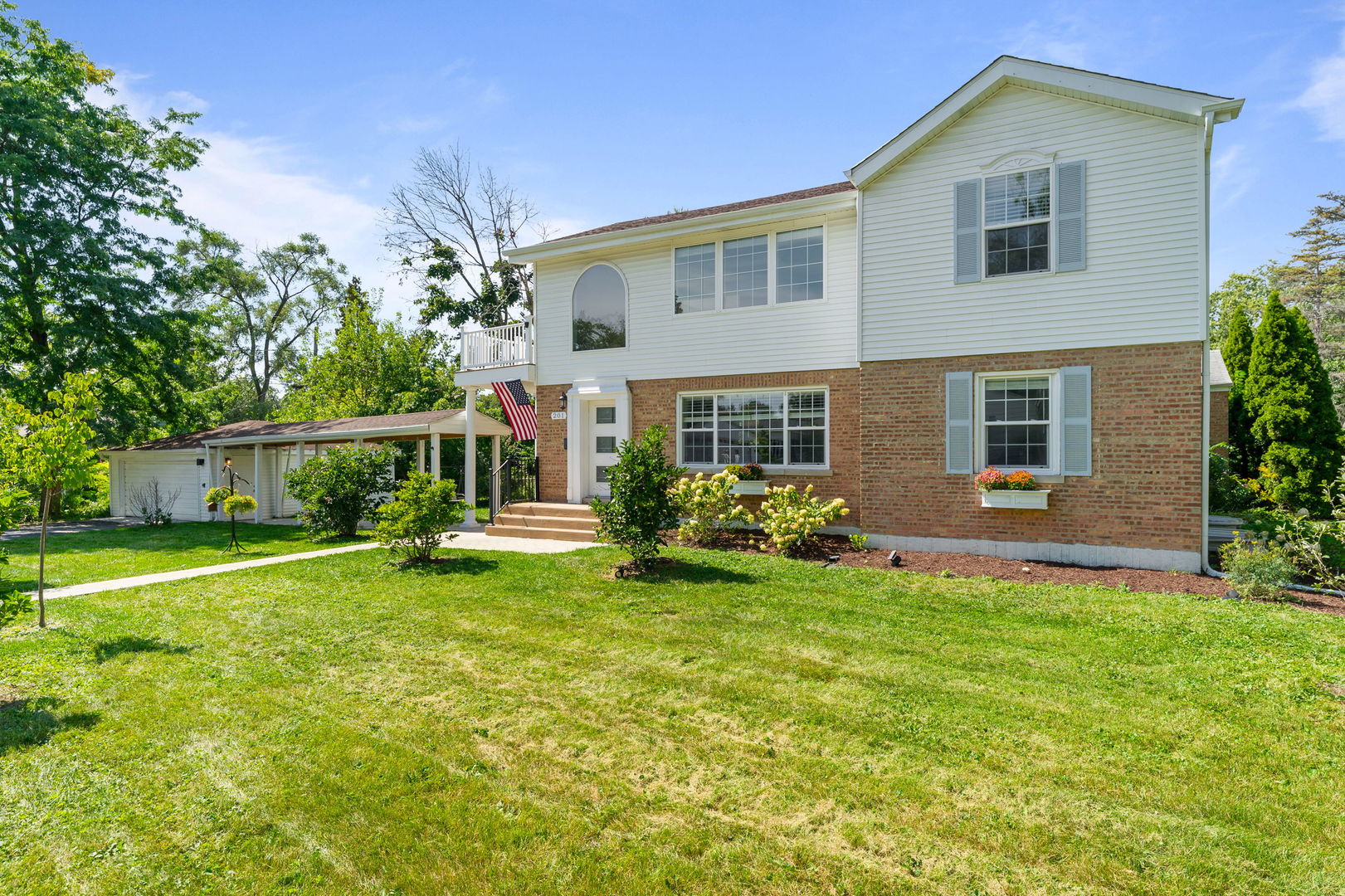 a view of a house with a yard and sitting area