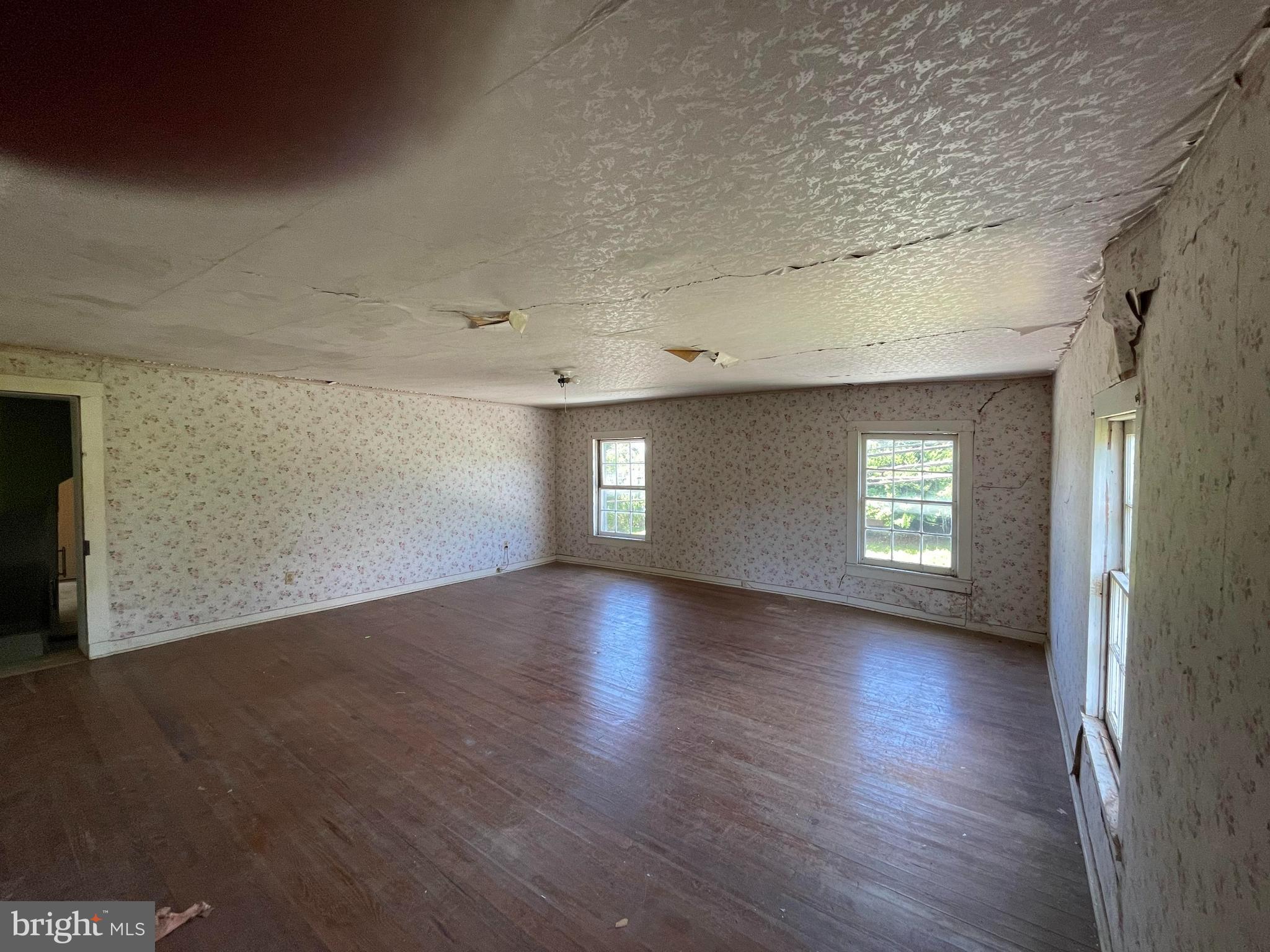 707 Old Liberty Road Sykesville, MD 21784 - Photo 14 of 31 an empty room with wooden floor and windows