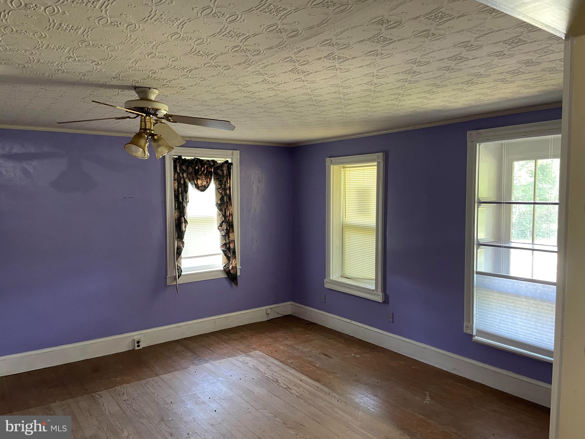 707 Old Liberty Road Sykesville, MD 21784 - Photo 18 of 31 an empty room with windows and chandelier fan