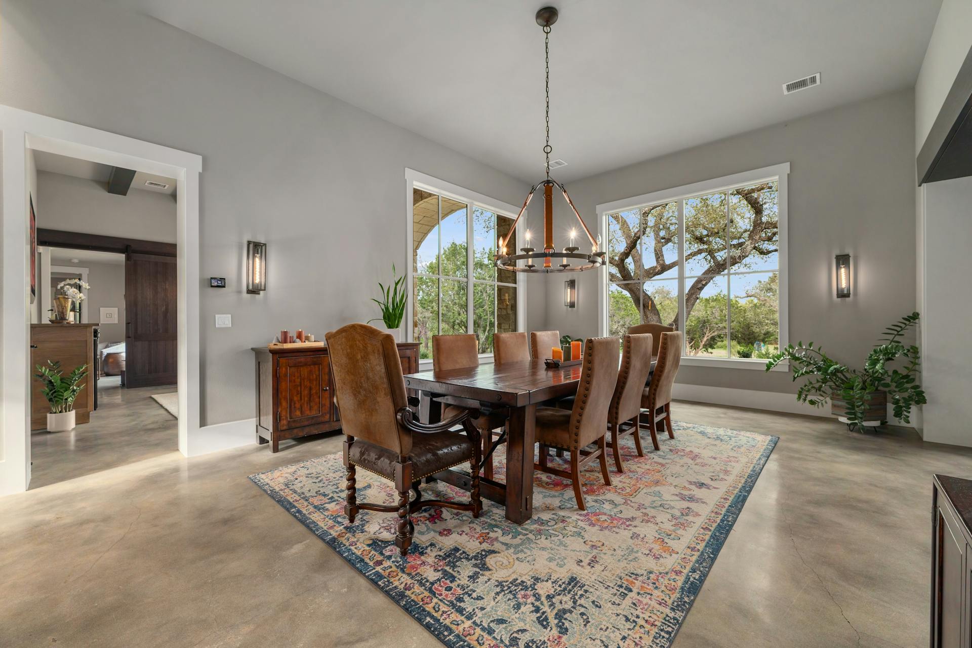 1330 Ranchers Club Lane Driftwood, TX 78619 - Photo 10 of 40 Dining room with a barn door, concrete floors, and hanging lights