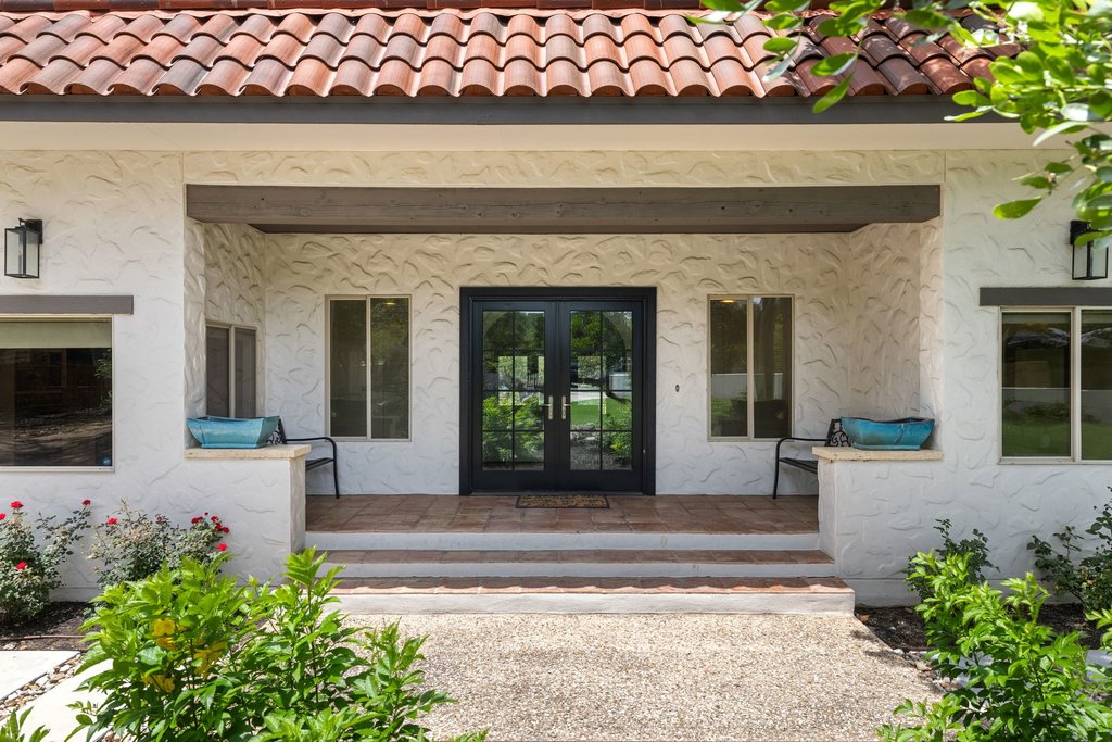 716 North Commons Ford Road Austin, TX 78733 - Photo 25 of 30 Spanish-style residence featuring a red tile roof and textured white stucco exterior