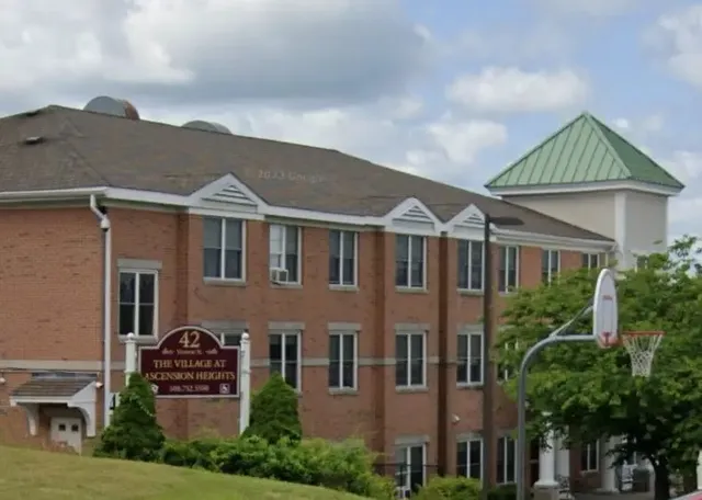 a view of a big house with a big yard plants and large trees