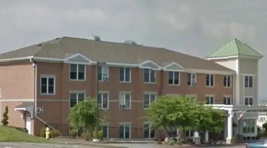 a front view of a house with a yard and potted plants