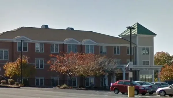 a front view of a building with parking