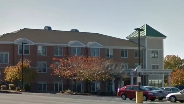 a front view of a building with parking