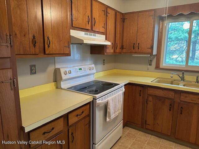 86 Pine Bush Road Stone Ridge, NY 12484 - Photo 10 of 30 a kitchen with stainless steel appliances granite countertop wooden cabinets a sink and a stove