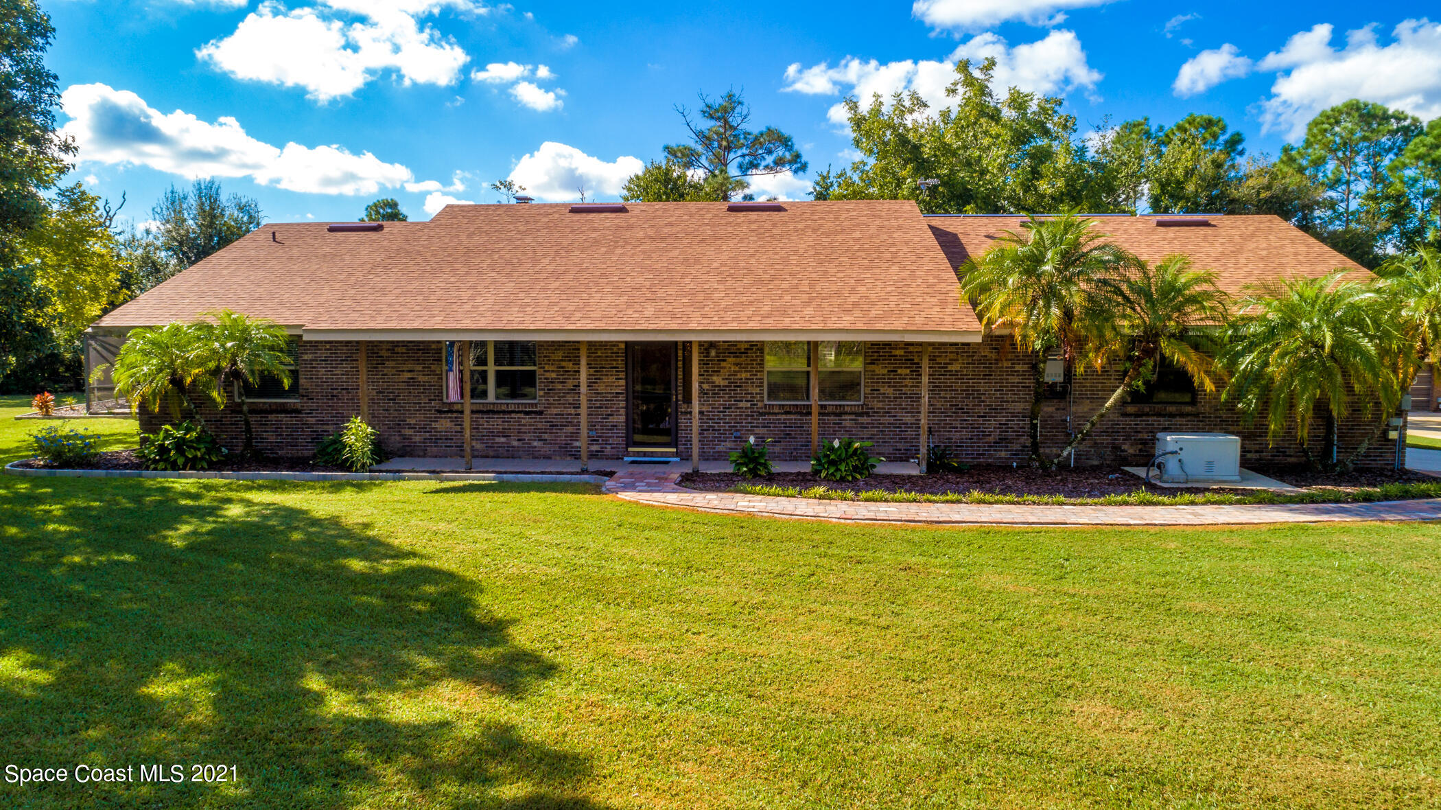 1390 Friday Road Cocoa, FL 32926 - Photo 2 of 69 a front view of a house with a garden