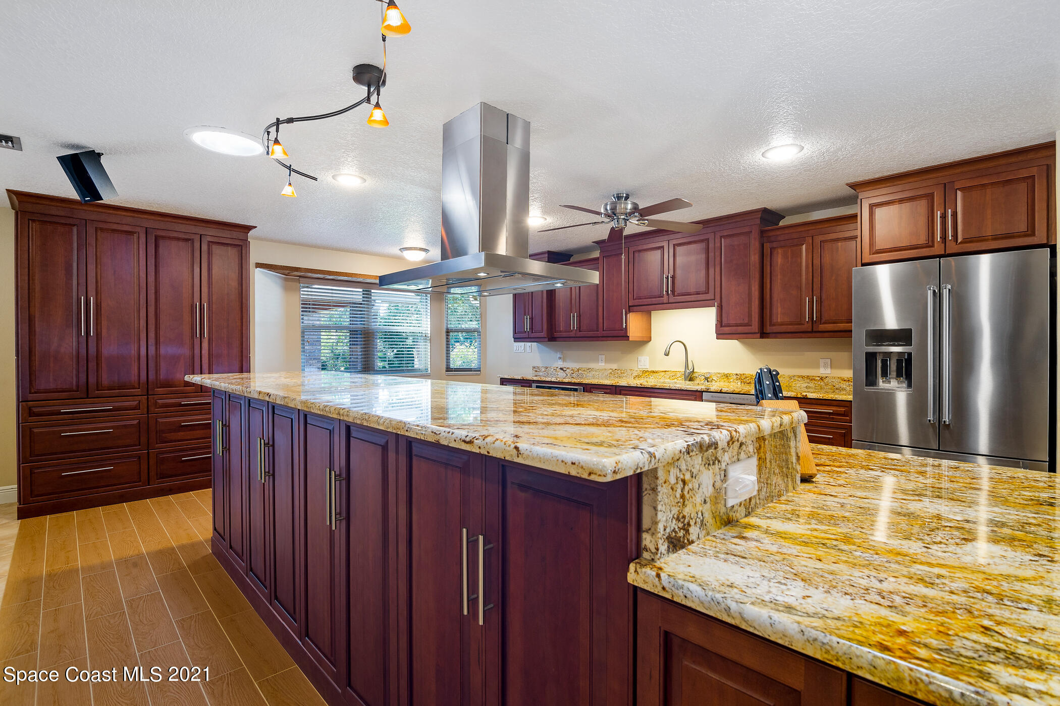 1390 Friday Road Cocoa, FL 32926 - Photo 14 of 69 a kitchen with stainless steel appliances granite countertop wooden cabinets a stove top oven a sink and dishwasher