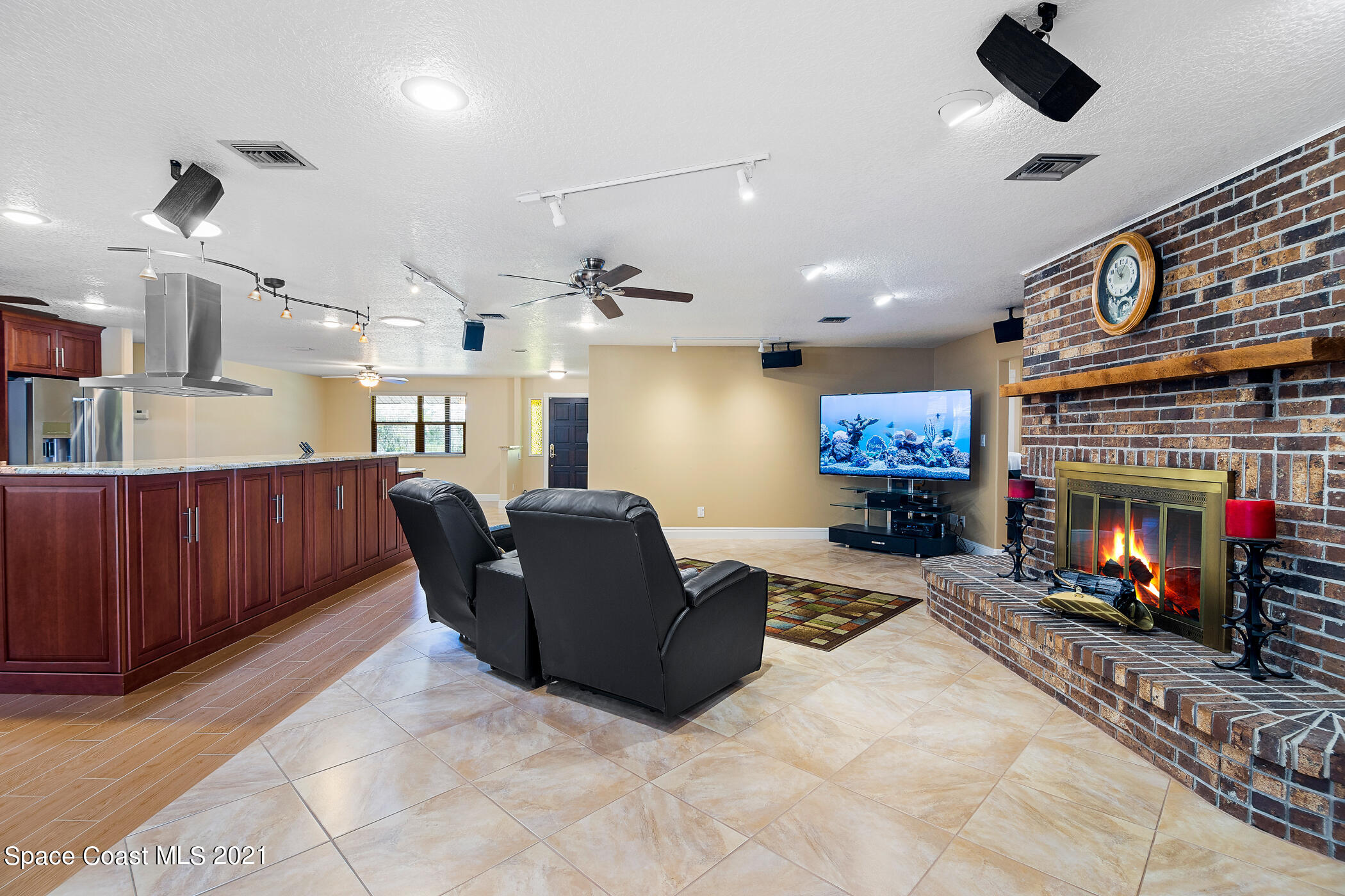 1390 Friday Road Cocoa, FL 32926 - Photo 19 of 69 a living room with furniture a fireplace and a flat screen tv