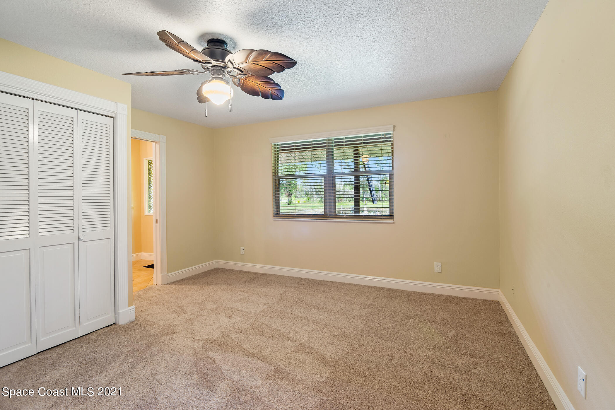 1390 Friday Road Cocoa, FL 32926 - Photo 22 of 69 an empty room with fan and windows