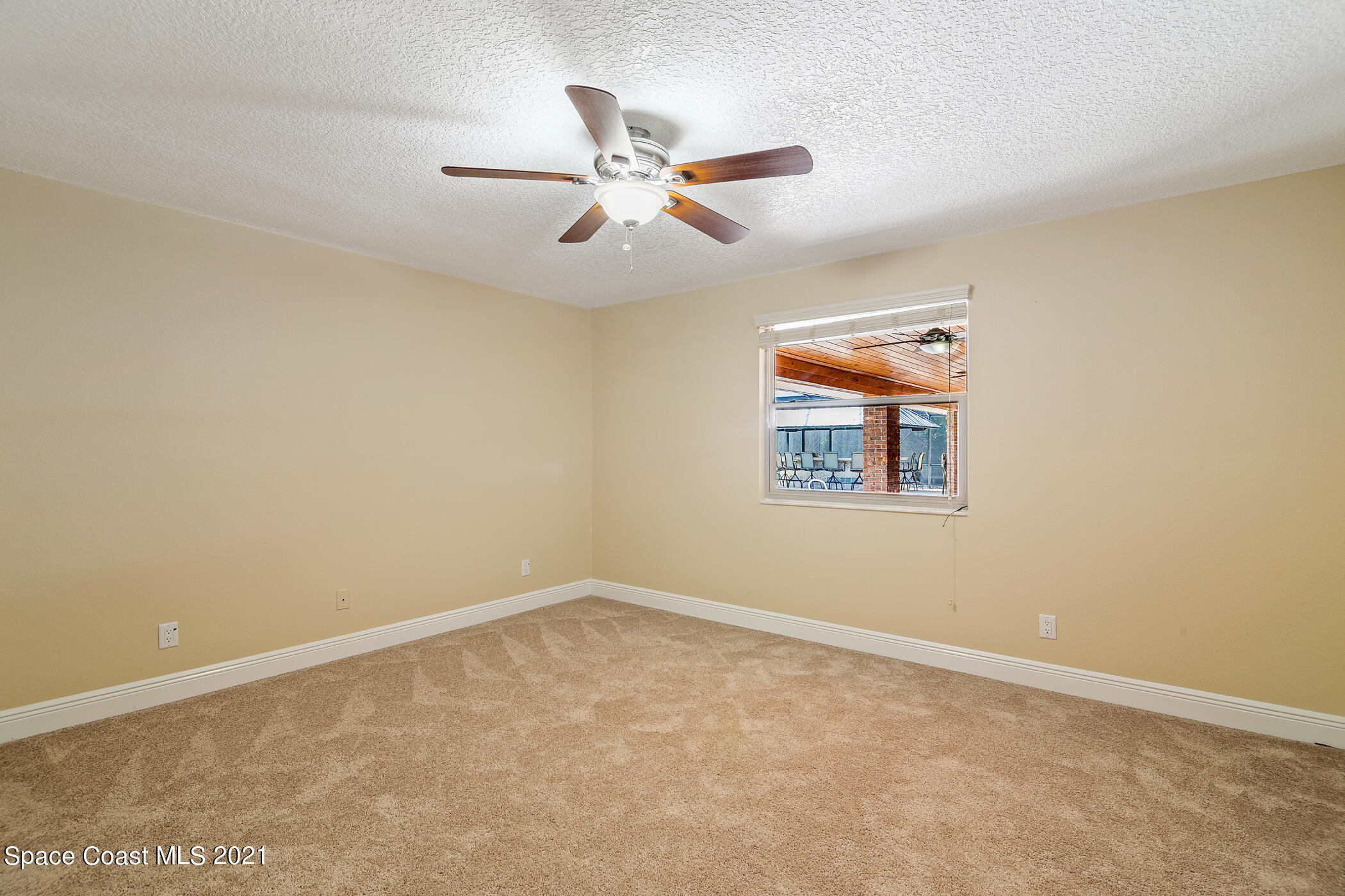 1390 Friday Road Cocoa, FL 32926 - Photo 28 of 69 an empty room with windows and fan