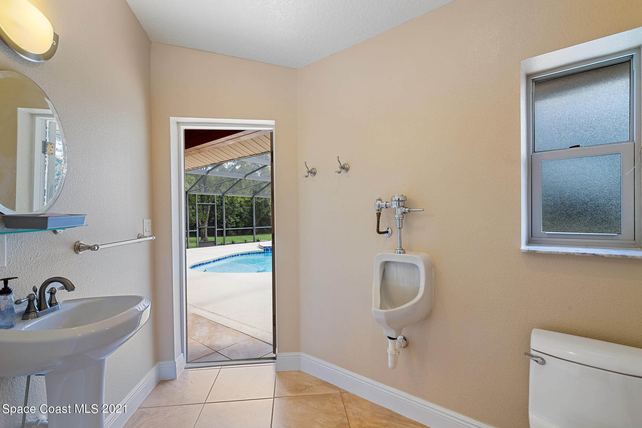 1390 Friday Road Cocoa, FL 32926 - Photo 32 of 69 a bathroom with a sink a toilet and mirror