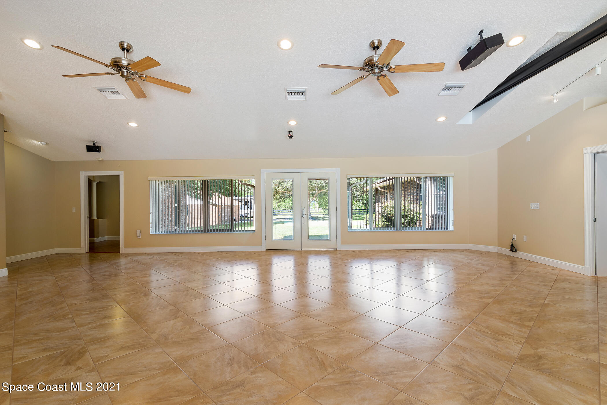 1390 Friday Road Cocoa, FL 32926 - Photo 35 of 69 an empty room with ceiling fan and windows