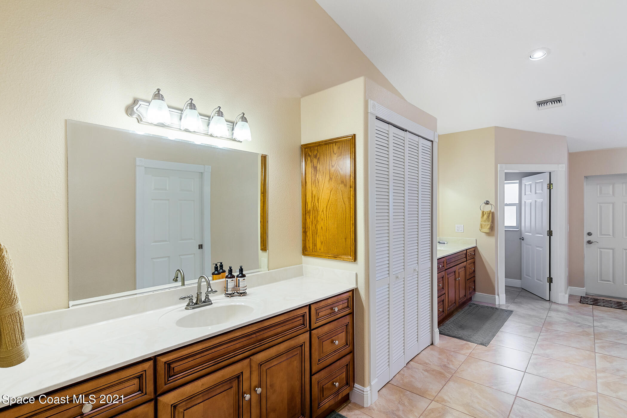 1390 Friday Road Cocoa, FL 32926 - Photo 37 of 69 a spacious bathroom with a double vanity sink a and mirror