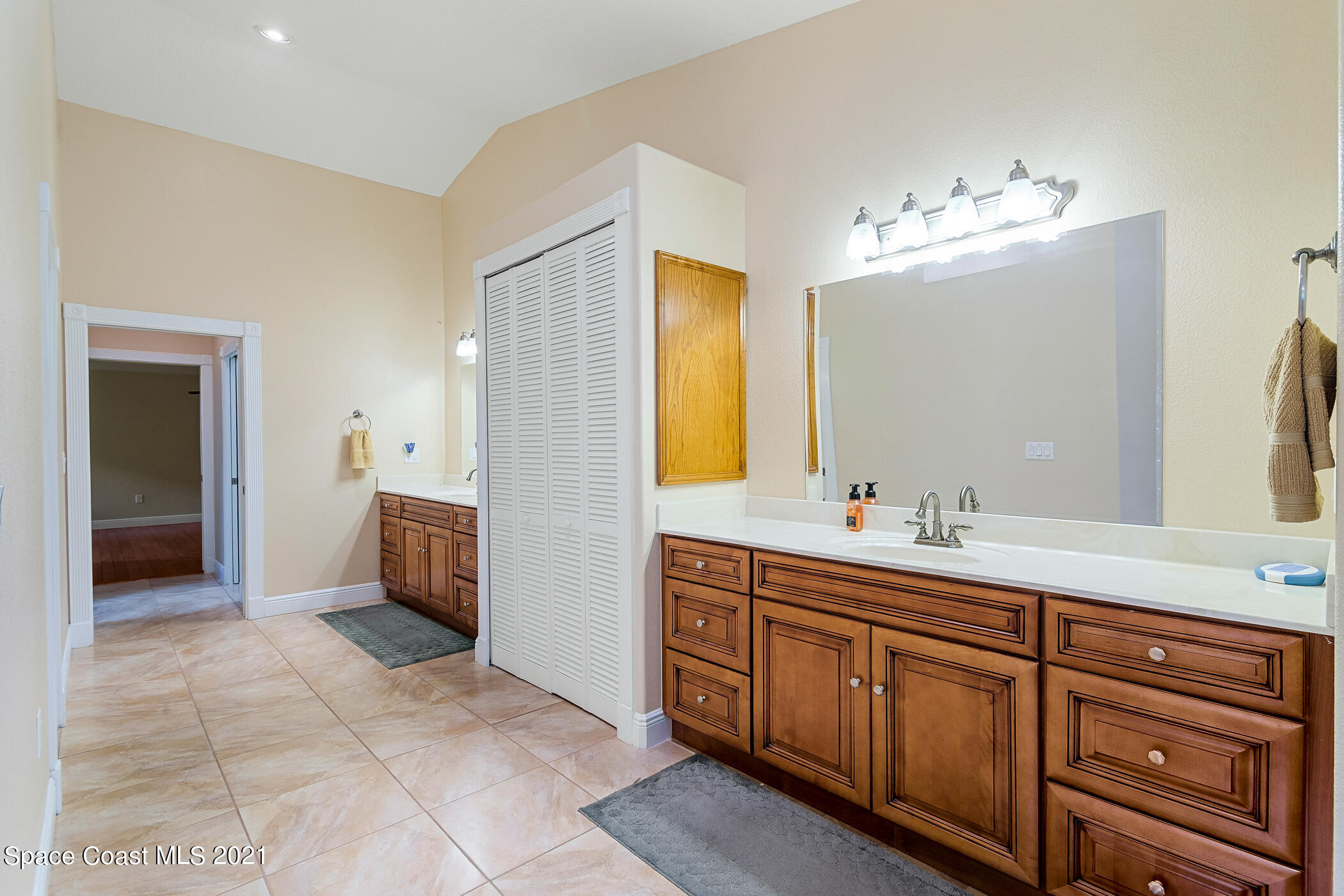 1390 Friday Road Cocoa, FL 32926 - Photo 41 of 69 a spacious bathroom with a double vanity sink a mirror and a